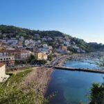 Small colorful houses standing on the coast of the blue sea showing what to do in Agropoli