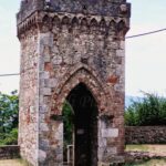 an old stone tower that looked defensive with a rather large gate