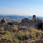runis-of-the-houses-panoraic-view-os-low-mounains-in-the-background in Craco