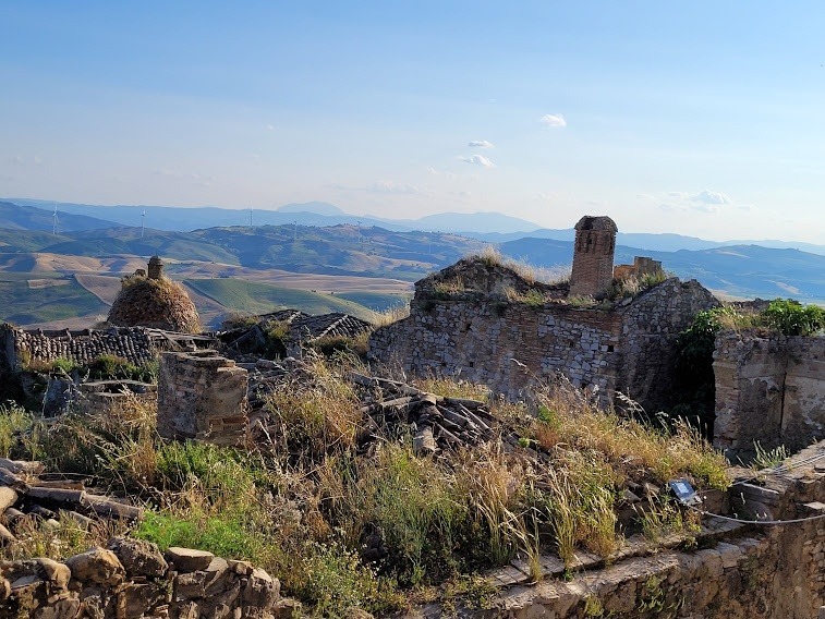 runis-of-the-houses-panoraic-view-os-low-mounains-in-the-background in Craco