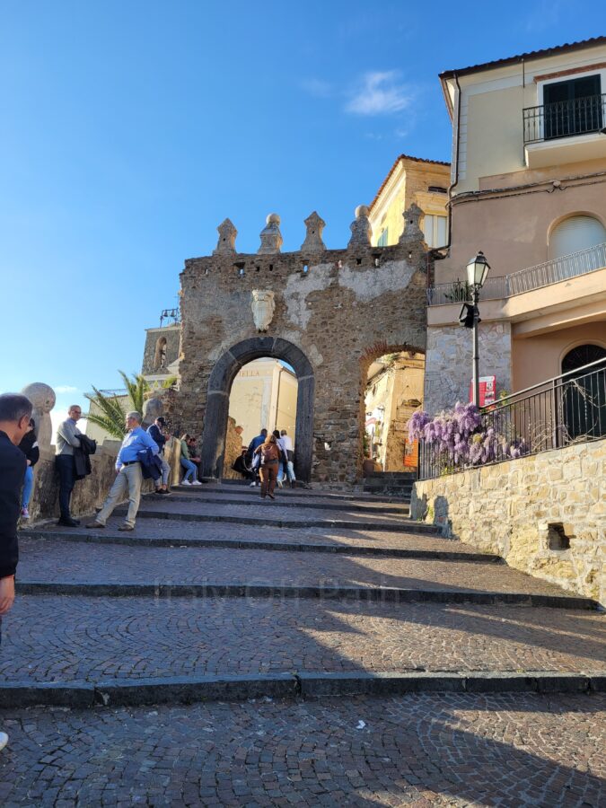 Stone steps leading to the historic city gate Porta di Agropoli in Campania with tourists walking up
