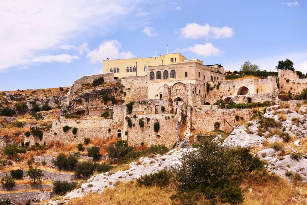 Abbey of Santa Maria di Pulsano built on rugged limestone cliffs near Monte Sant'Angelo in Gargano, Puglia, Italy.