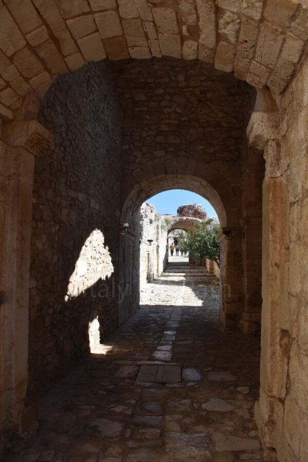 Stone archways and vaulted corridor inside the Abbey of Santa Maria di Pulsano in Gargano, Puglia.