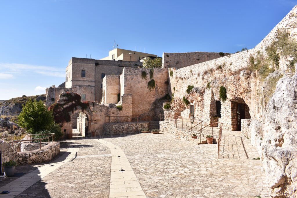 Inner stone courtyard and cave entrances of the Abbey of Santa Maria di Pulsano in Gargano, Puglia.