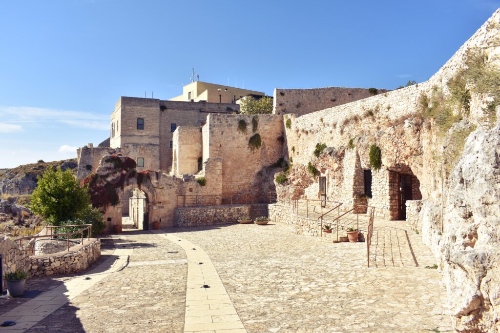 stone courtyard of a medieval light stone building in Pulsano Abbey in Gargano