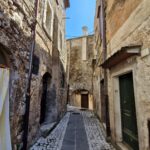 An old stone street between old houses