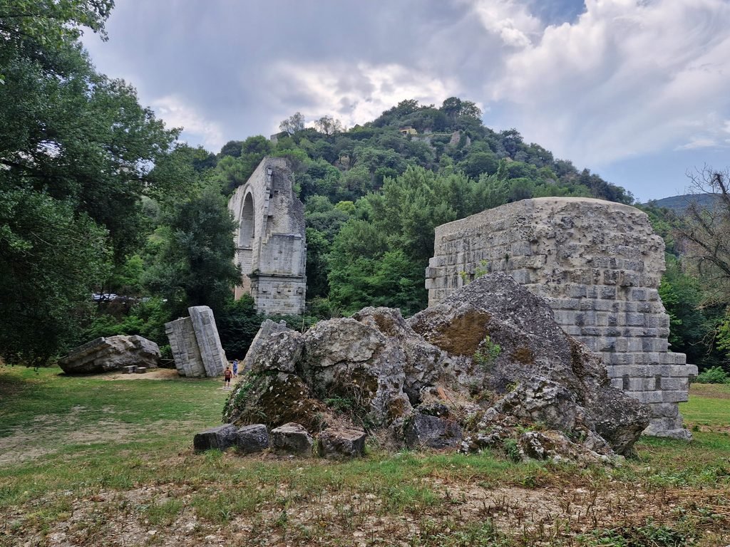 Panorama of stone medieval houses and bell towers built on a steep hillside in Narni, Umbria.
