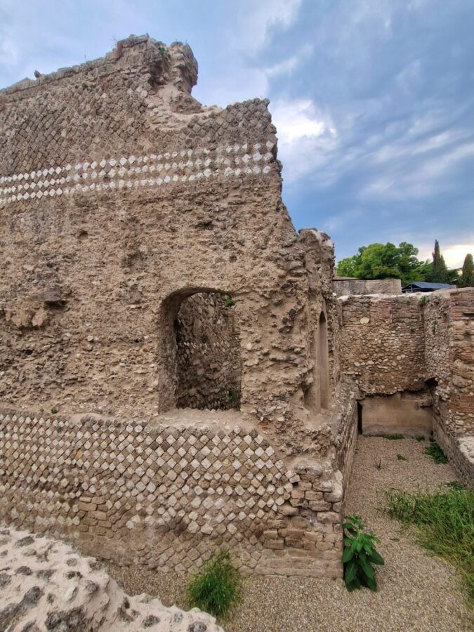 Ancient stone wall ruins of the Roman amphitheater in Terni Umbria Italy showing opus reticulatum brickwork