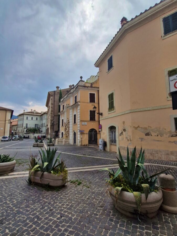 Cobblestone square with stone planters and historic buildings in Terni old town Umbria