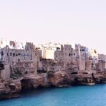 Historic stone houses of Polignano a Mare built on cliffs above the Adriatic Sea in Puglia, Italy.