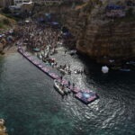Crowds and boats gathered at Lama Monachile beach in Polignano a Mare, Puglia, during the Red Bull cliff diving event.
