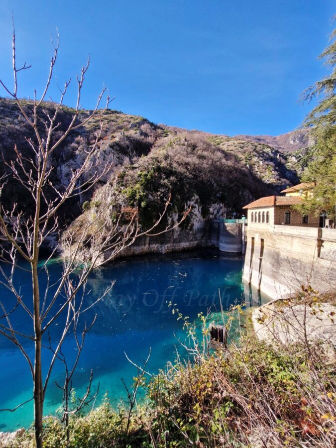 Lake San Domenico in Abruzzo with crystal-blue water, rocky gorge and hydroelectric dam during Off-Season Travel in Abruzzo Abruzja zimą