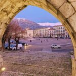 View of the main square in Sulmona through the arches of the medieval aqueduct