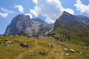 La Madonnina cable car station on the way grassy slope with the rocky peaks while hiking Corno Grande in the Gran Sasso massif, Abruzzo, Italy