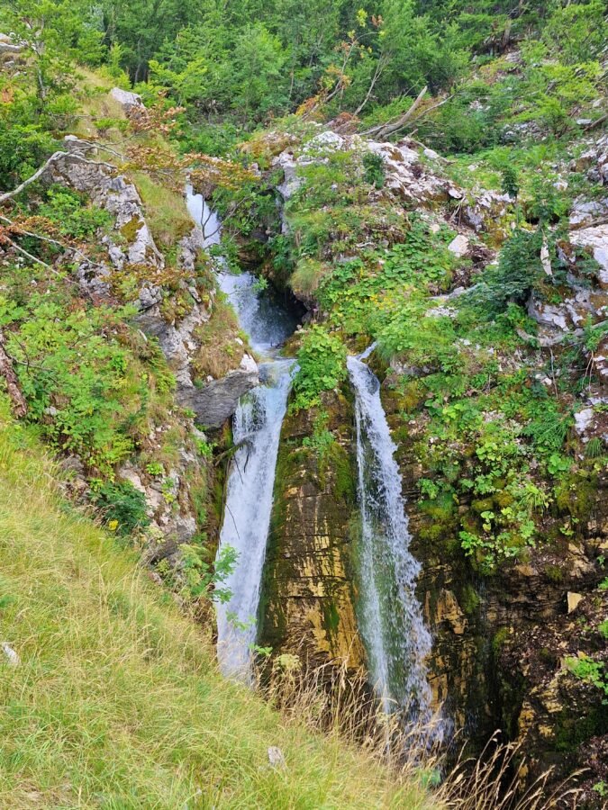 Cascata del Rio Arno waterfall splitting into two streams over rocky cliffs in Gran Sasso National Park near Prati di Tivo, Abruzzo, Italy