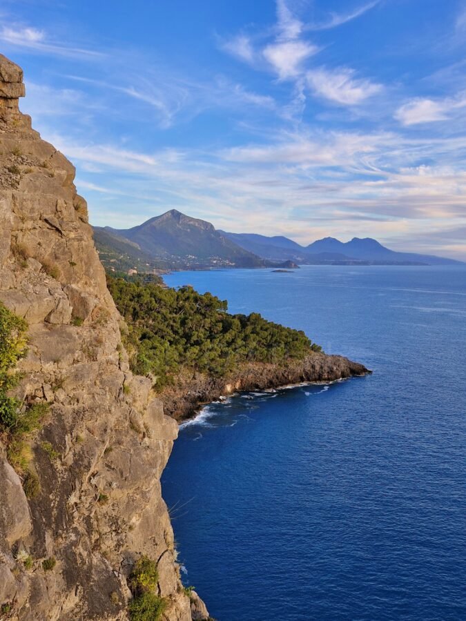 View from the skywalk of steep rocky cliffs dropping into the blue sea along the Maratea coastline in Basilicata, Italy.
