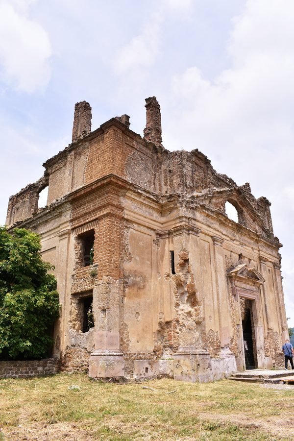 Exterior walls and entrance portal of the ruined Church and Monastery of San Bonaventura in the ghost town of Antica Monterano, Lazio, Italy.