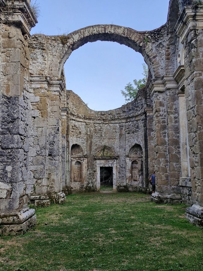 Stone archway, niches, and ruined interior walls of Ninfeo del Bramante in Genazzano, Lazio, Italy.