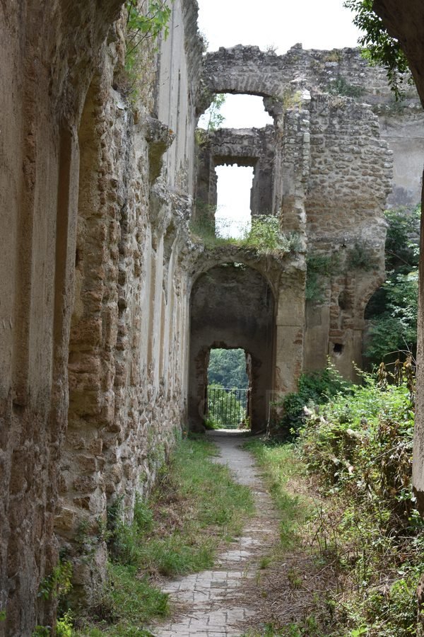 Interior ruins and arched corridor of the Church and Monastery of San Bonaventura in the ghost town of Antica Monterano, Lazio, Italy.