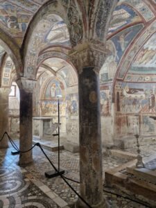 Medieval frescoes and Cosmatesque mosaic floor inside the Crypt of St Magnus Anagni Cathedral, Lazio, Italy.