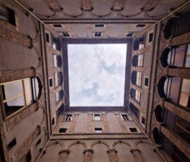 Upward view through the square open roof opening of Palazzo Spada toward the sky in Terni Umbria