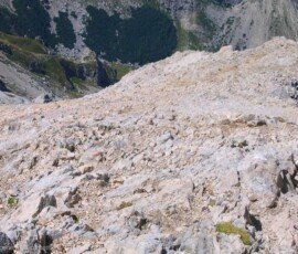 Steep and exposed limestone scree slope on the final stretch of the trail leading to the summit of Corno Grande, Gran Sasso, Abruzzo, Italy.