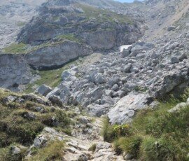 Steep rocky trail covered in loose boulders and scree leading up towards the summit of Corno Grande in the Gran Sasso massif, Abruzzo, Italy.