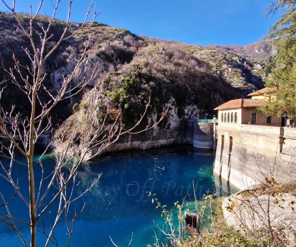 Lake San Domenico in Abruzzo with crystal-blue water, rocky gorge and hydroelectric dam during Off-Season Travel in Abruzzo Abruzja zimą