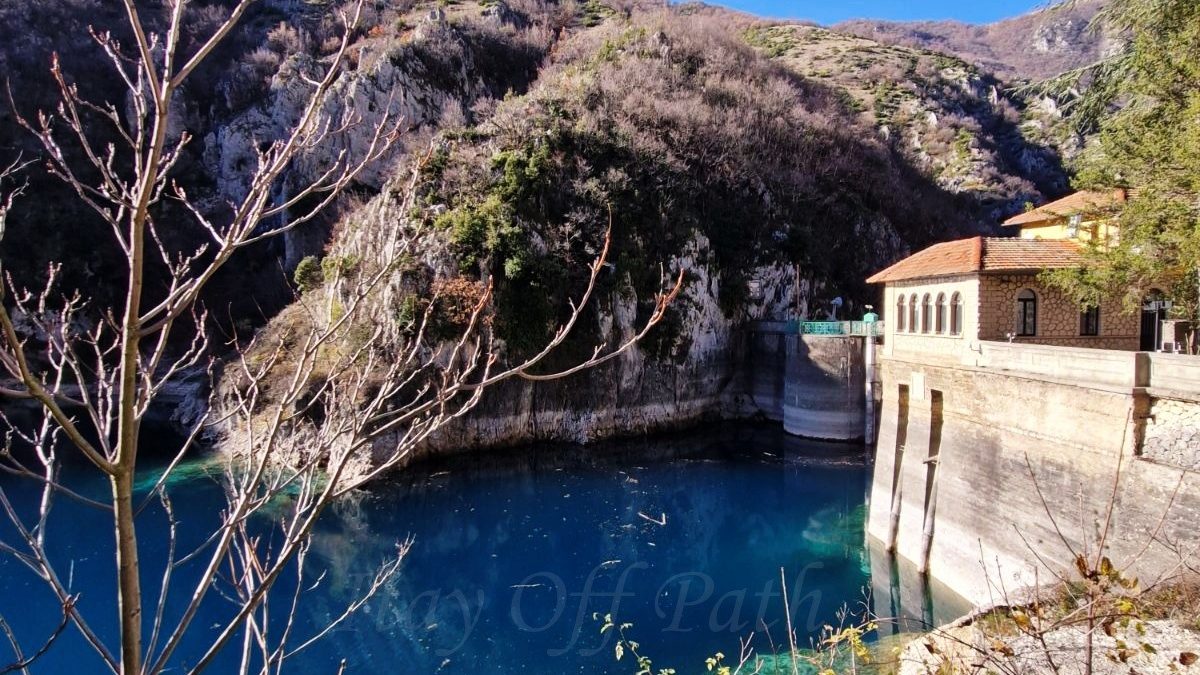 Lake San Domenico in Abruzzo with crystal-blue water, rocky gorge and hydroelectric dam during Off-Season Travel in Abruzzo Abruzja zimą