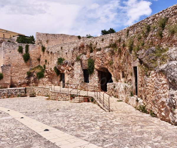 Pulsano Abbey - Low-rise building with multiple entrances and windows.