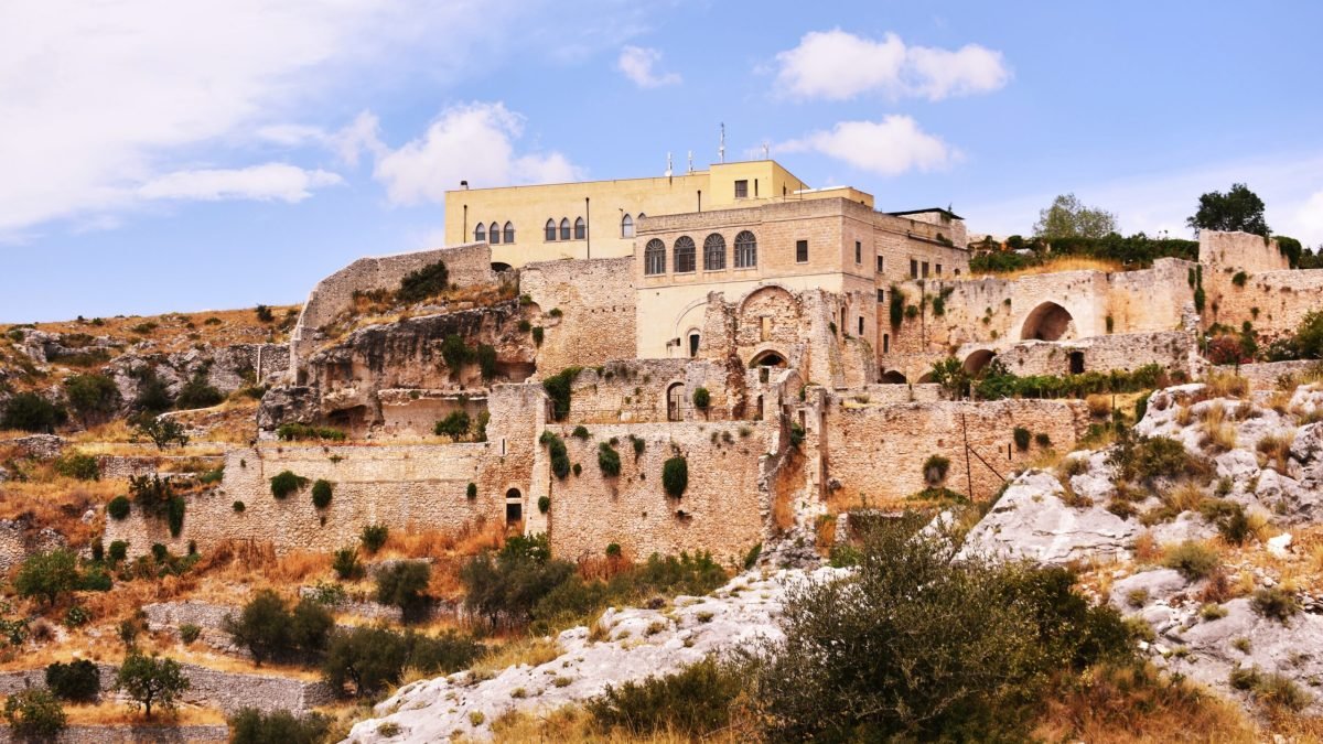 Abbey of Santa Maria di Pulsano built on rugged limestone cliffs near Monte Sant'Angelo in Gargano, Puglia, Italy.