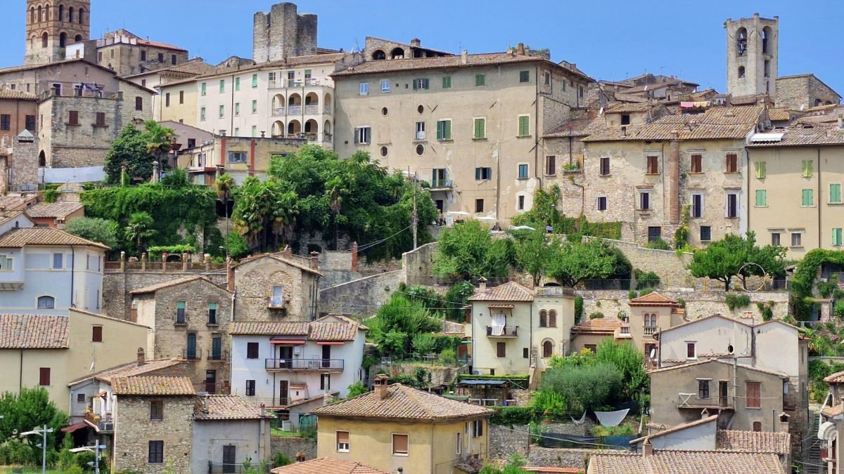 Things to do in Narni. Panorama of stone medieval houses and bell towers built on a steep hillside in Narni, Umbria.
