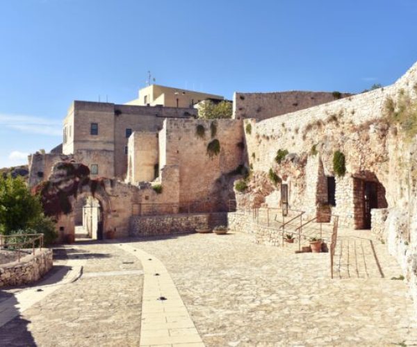 stone courtyard of a medieval light stone building in Pulsano Abbey in Gargano